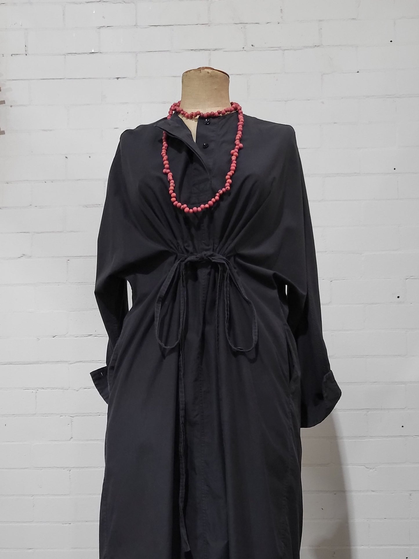 Front view of oversized black Lee Mathews t-shirt dress with drawstring waist