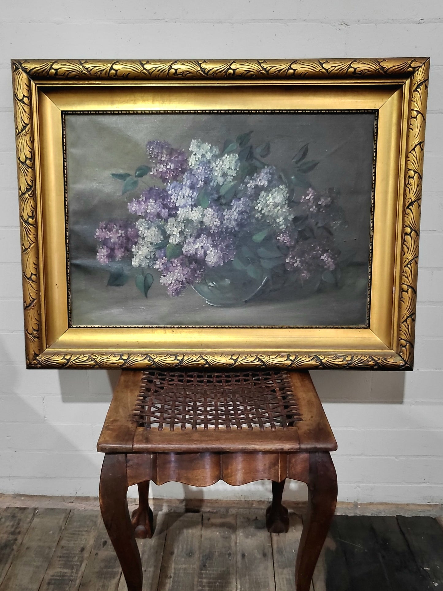Antique oil painting of a still life bouquet of white and purple lilacs in an ornate gold gilt frame, c.1920s