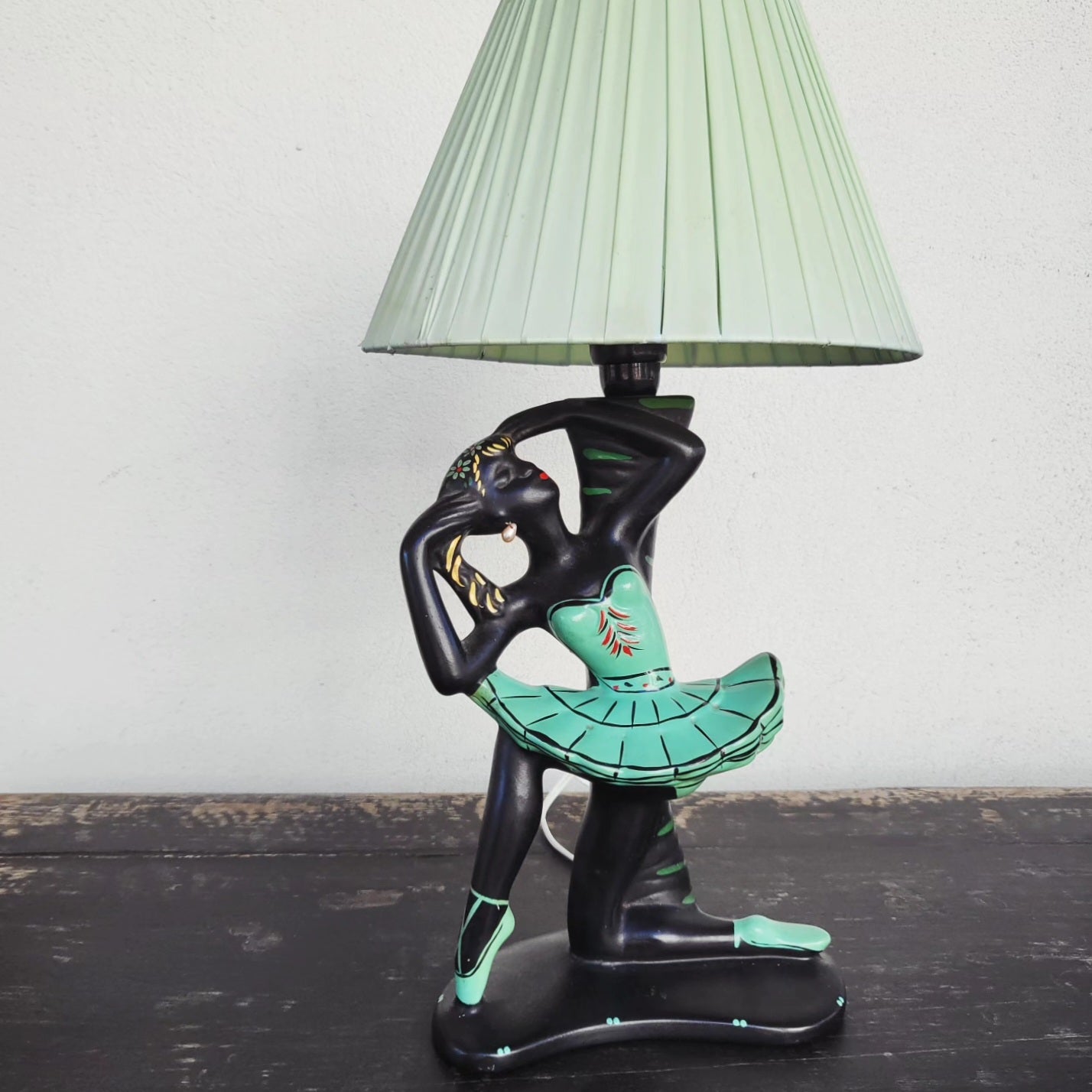 Front view of authentic Barsony ballerina lamp, 1950s, black ceramic with green dress and original shade