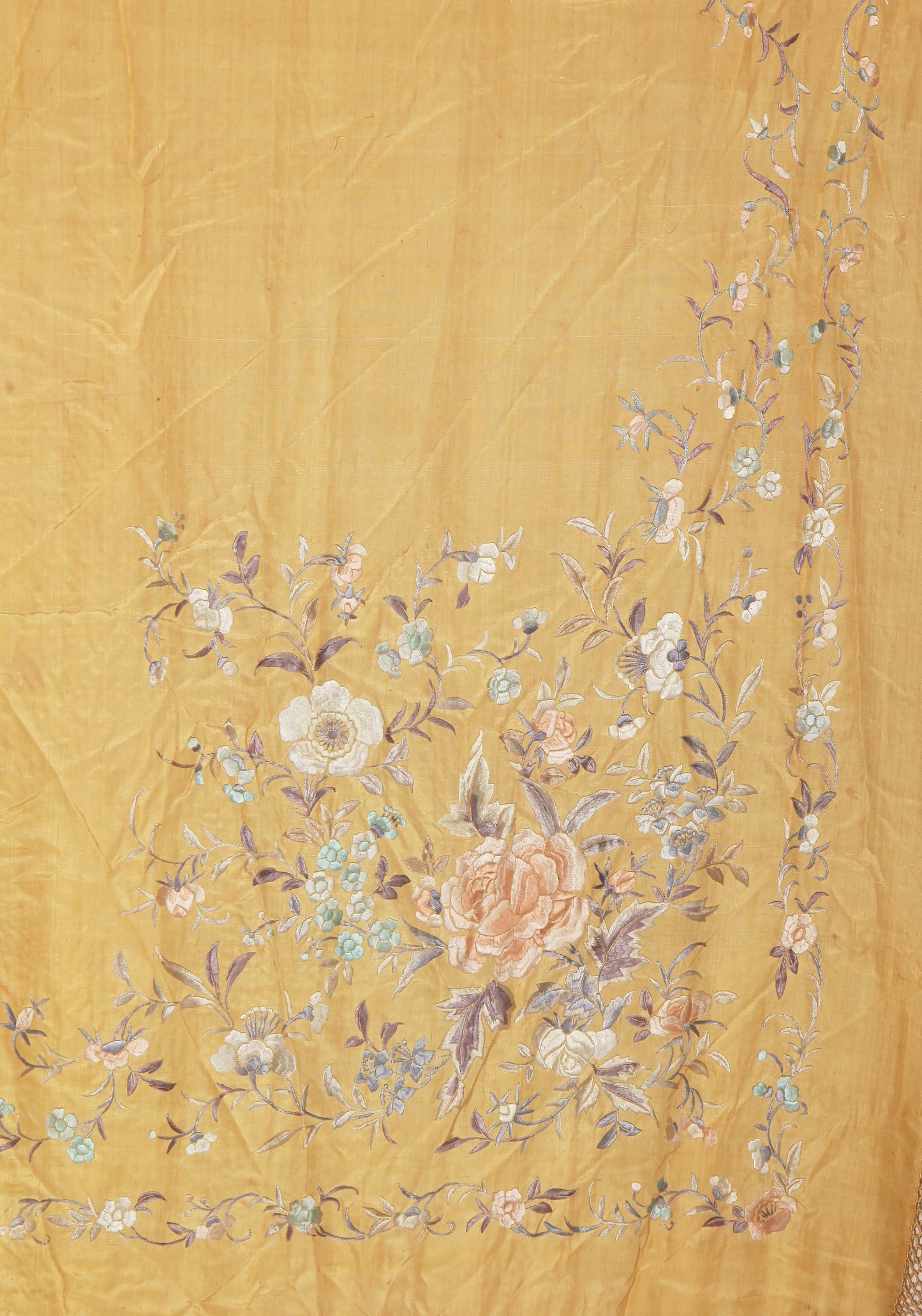 Golden ochre early 20th century silk shawl with pastel hand-embroidered floral motifs and long hand-knotted fringe.