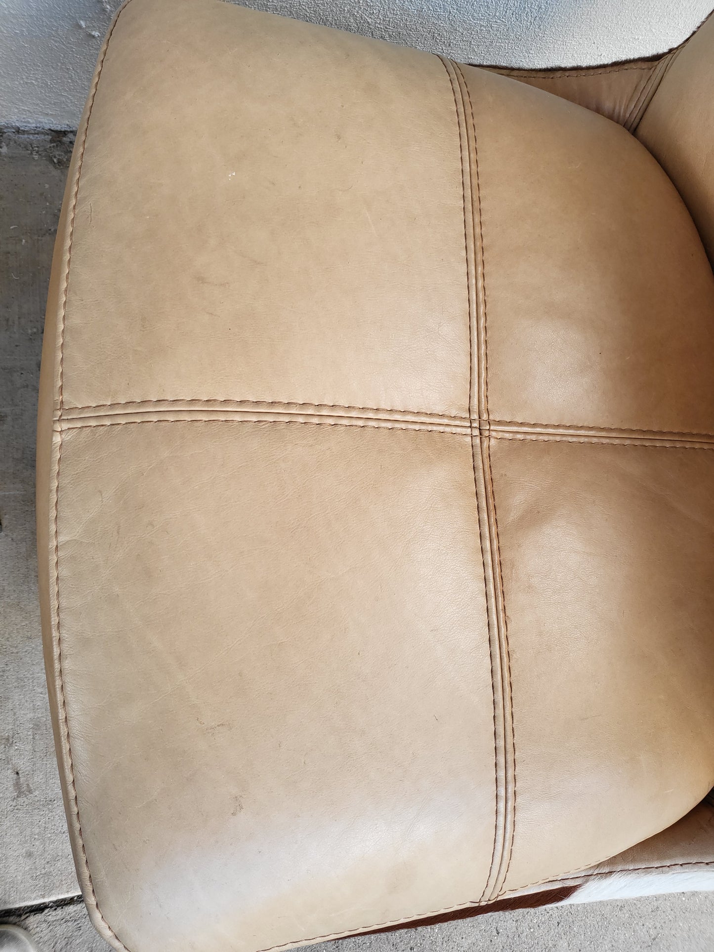 Cow Hide and Leather Swivel Armchair and Ottoman