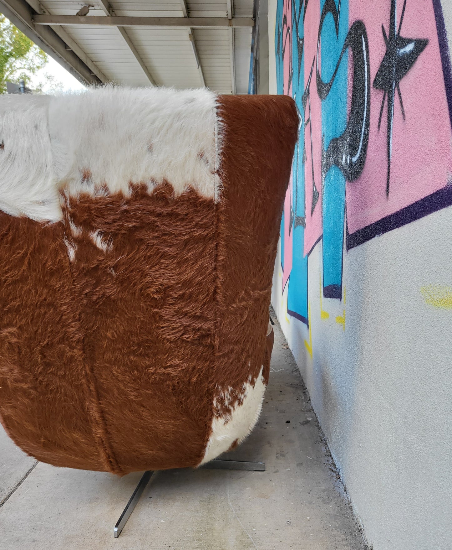 Cow Hide and Leather Swivel Armchair and Ottoman