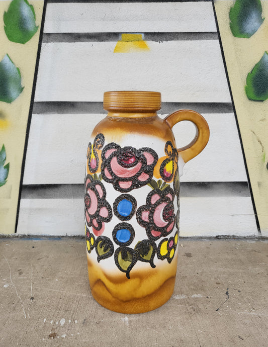 Large 55cm West German floor vase with raised floral decoration in pink, blue, and yellow on ochre glaze