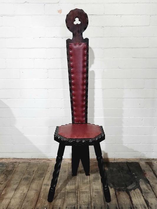Mid-century Spanish carved wood chair with studded oxblood vinyl seat and high backrest, Brutalist style accent chair