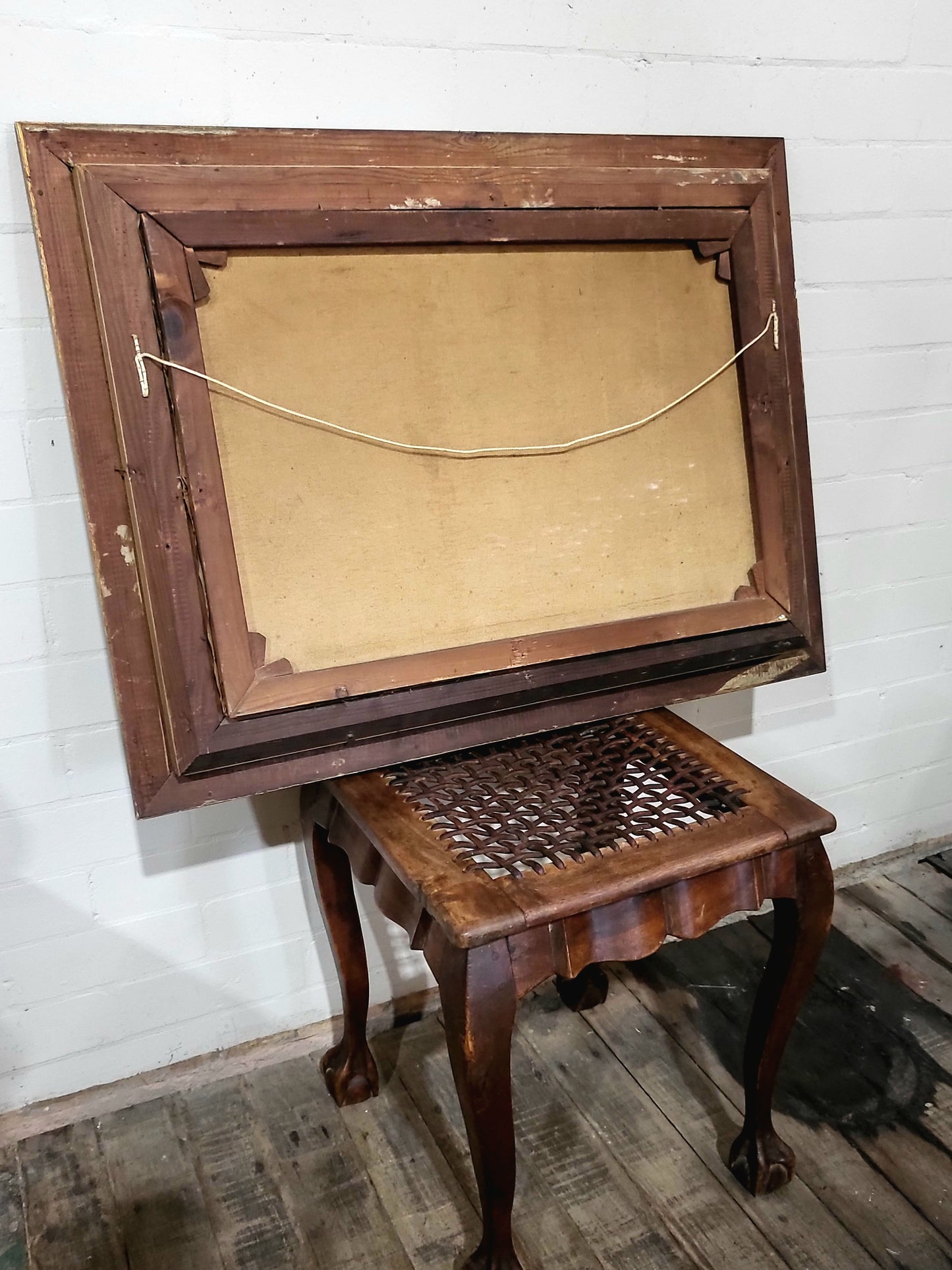Back of antique oil painting frame showing solid timber with patina and butt-joined corners, early 1900s construction