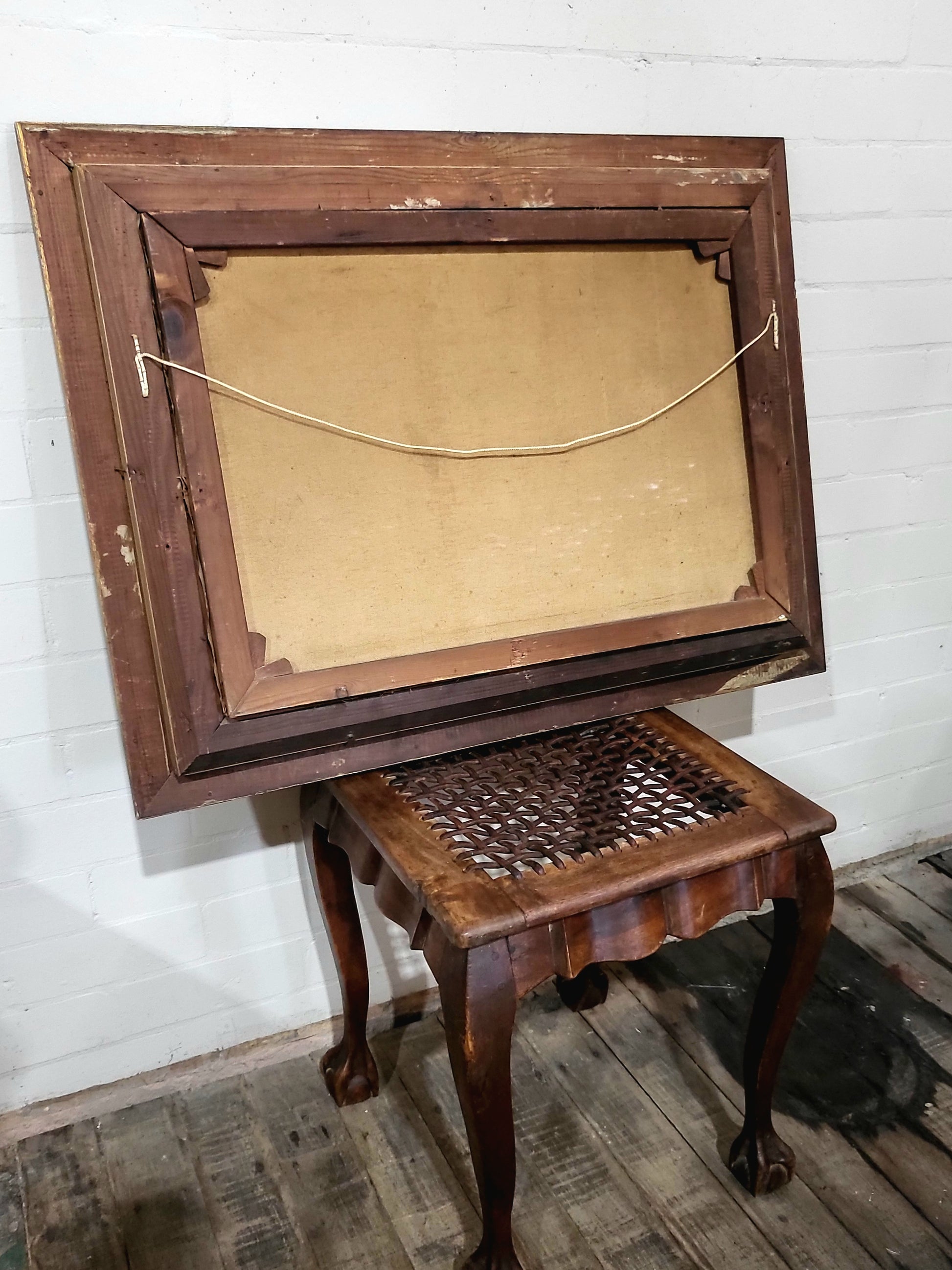 Back of antique oil painting frame showing solid timber with patina and butt-joined corners, early 1900s construction