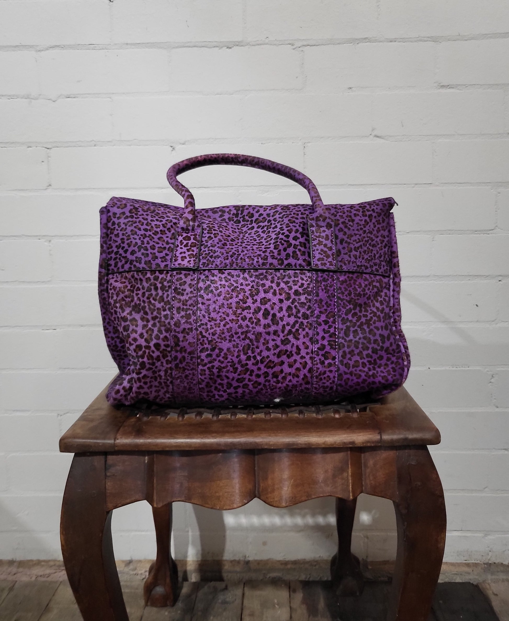 Back view of Mulberry Bayswater purple leopard pony hair handbag, British luxury design.