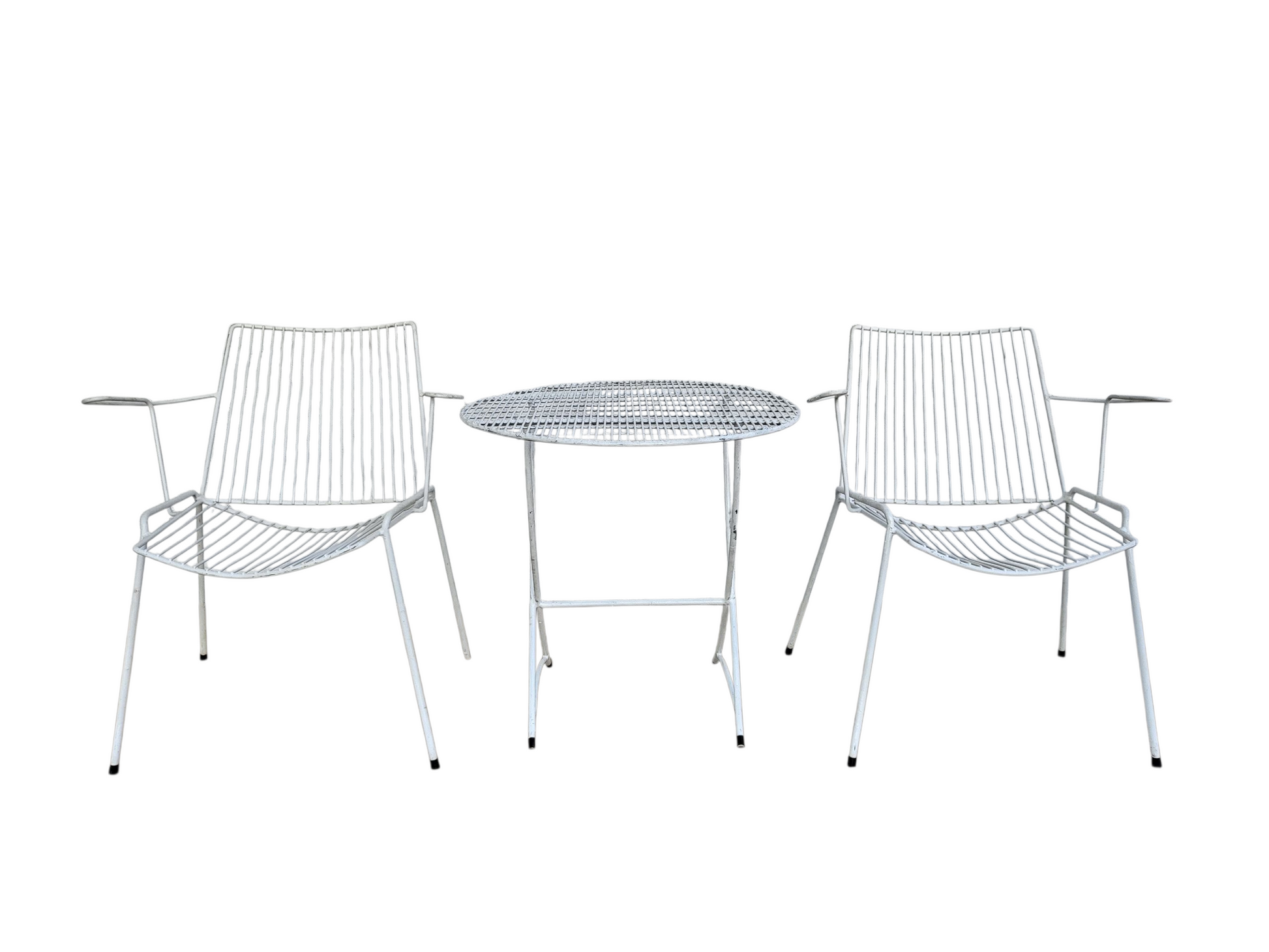 Pair of white wire Breotex armchairs showing sculptural mid-century design and gentle patina.