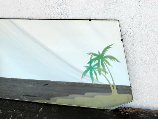 Mid-century bevel-edged mirror with reverse-painted tropical palm tree motif, featuring clipped corners and chain-hanging points