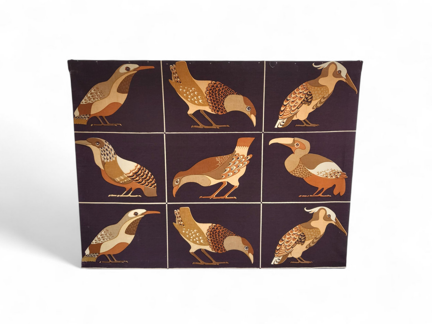 Mid-century fabric wall panel with nine stylised birds in warm earthy tones, mounted on a wooden frame and ready to hang.
