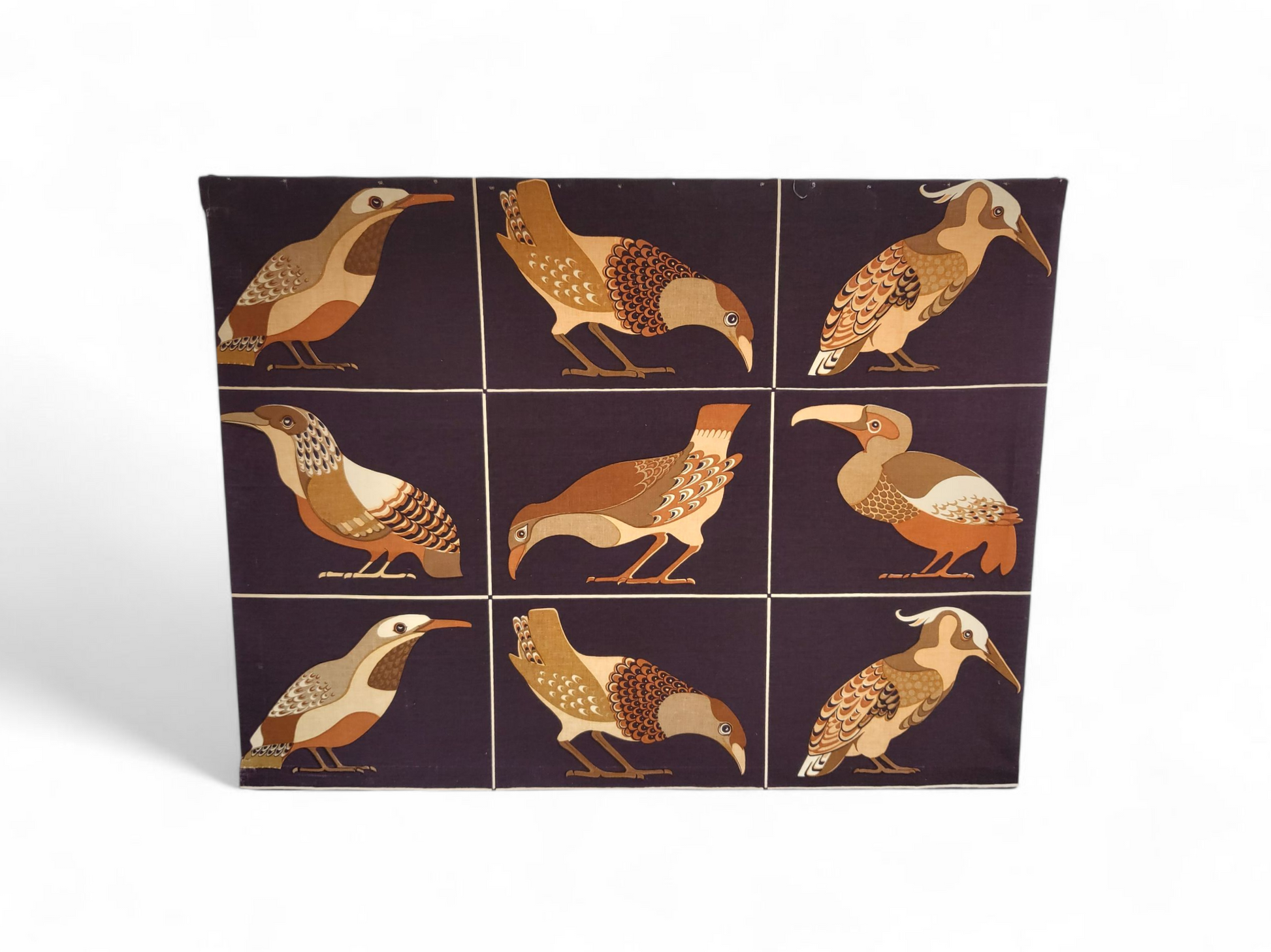 Mid-century fabric wall panel with nine stylised birds in warm earthy tones, mounted on a wooden frame and ready to hang.