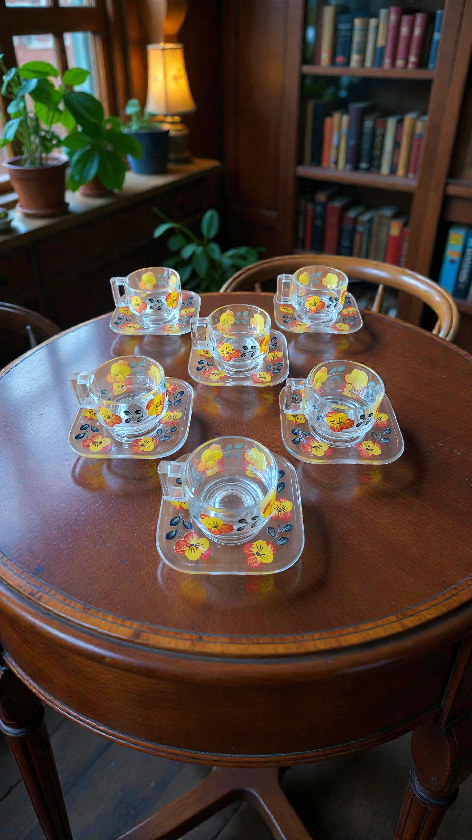 Joe Colombo glass mugs and saucers on wooden table 