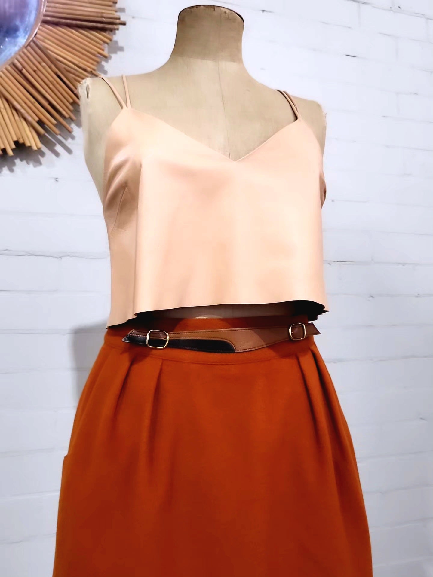 Detail of double gold buckle waistband on vintage Hermès wool skirt”